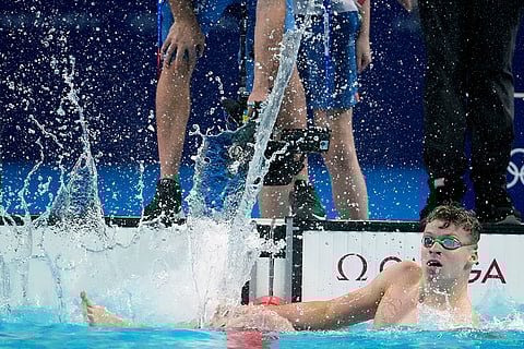 Leon Marchand celebrates after winning the men's 200-meter breaststroke